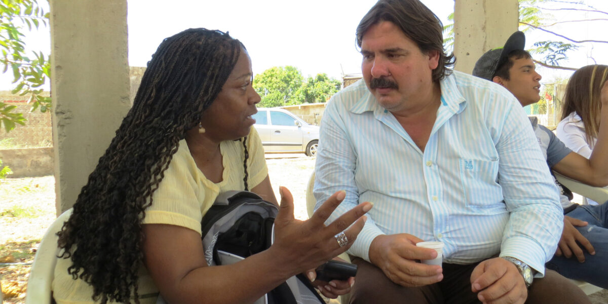 Zaraí Gonzalía (left) and Erwin Mirabal converse at Comunidad Cristiana del Camino in Espinal