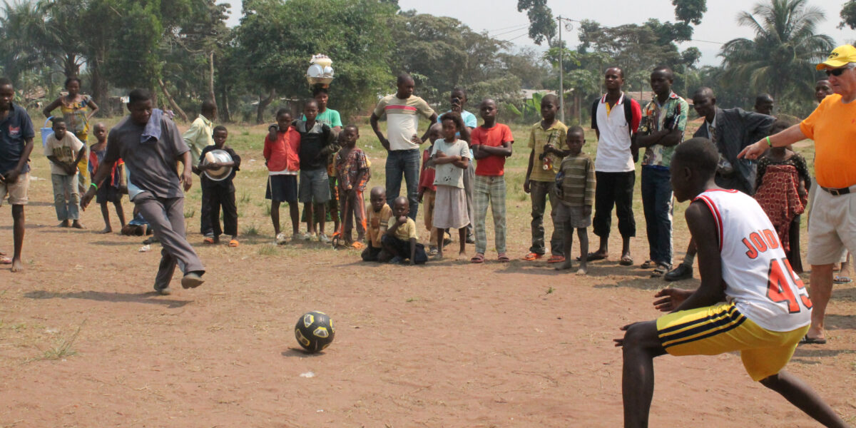 ​Robert Irundu demonstrates how to finish off a penalty kick during a Mennonite youth camp in Congo.
