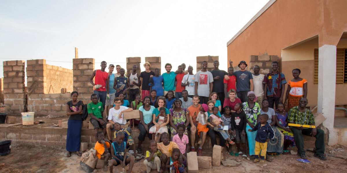 Mennonite youth from Burkina Faso and France take a break from building a school by the newly established Mennonite church in Coma