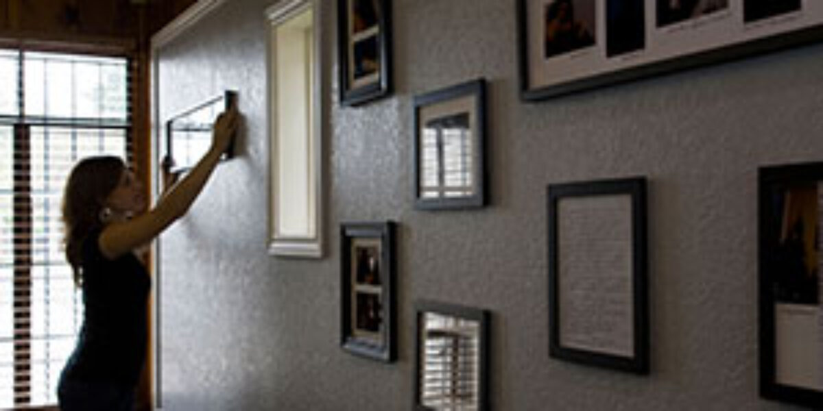 Carrie Vander Hoek adds a photo to the wall at ProBAR.