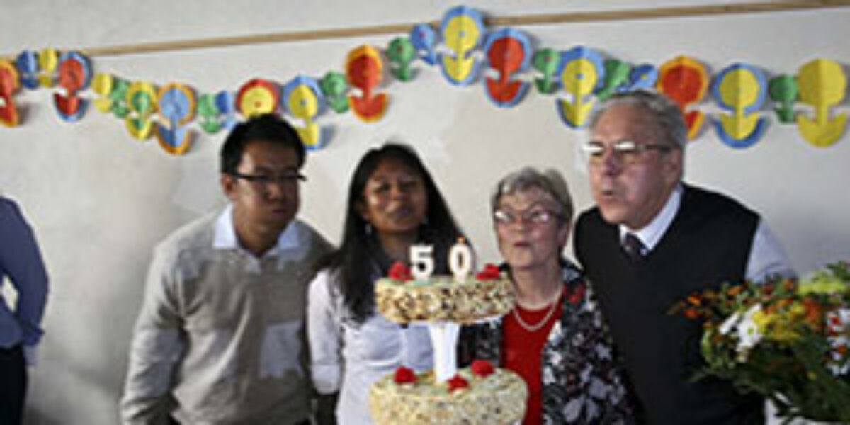 Salohy Rakotonindriana and Erika Kennel blow out candles.