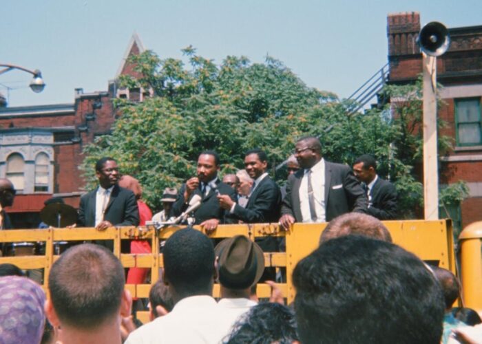 ​Martin Luther King, Jr. speaks to a crowd before a march in Chicago. Photo by Neill von Gunten.