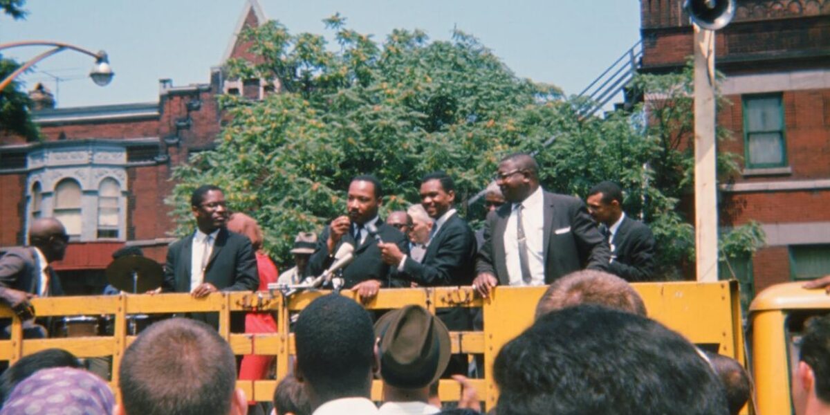 ​Martin Luther King, Jr. speaks to a crowd before a march in Chicago. Photo by Neill von Gunten.