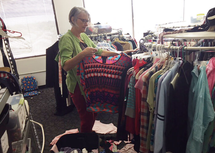 Betty Histand sorts clothing at International Rescue Committee's clothing distribution center in Phoenix