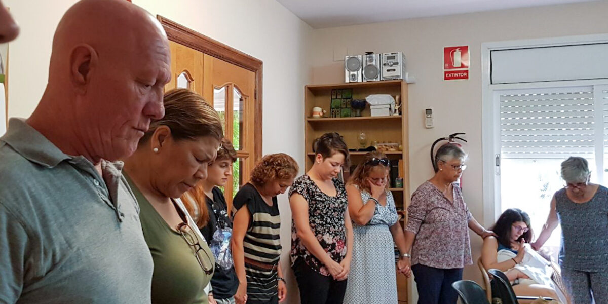 Members of Comunidad Evangélica Menonita in Barcelona gather for prayer on Sunday