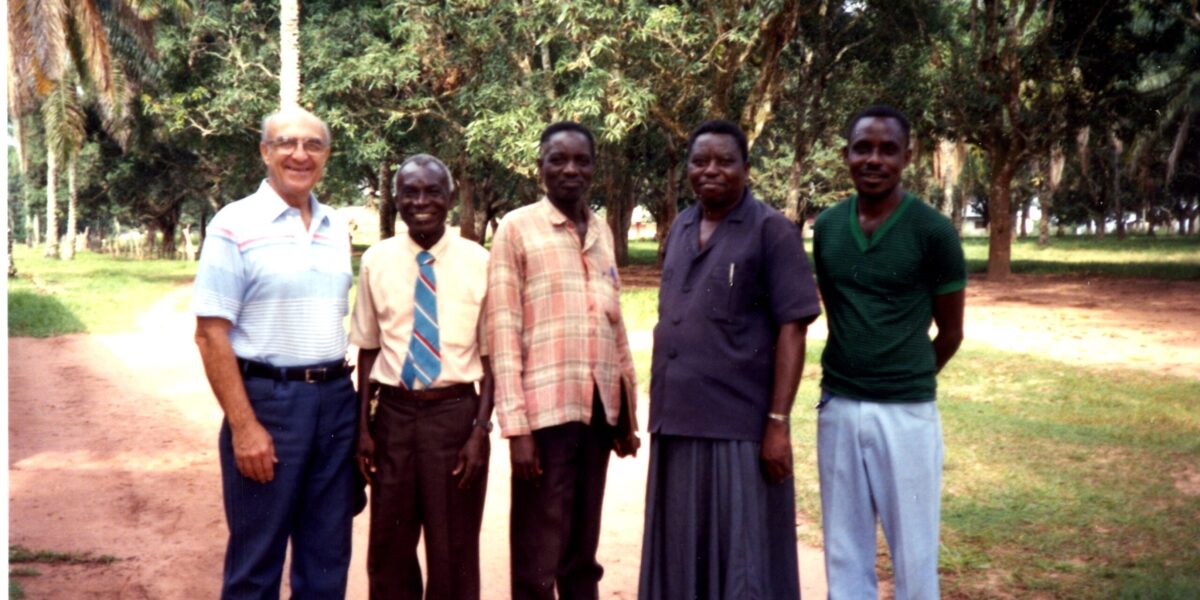 ​Earl Roth (left) greets Chief Nyanga (second from right) and other friends on an administrative trip to Congo in 1993. Photo from MCUSA archives.