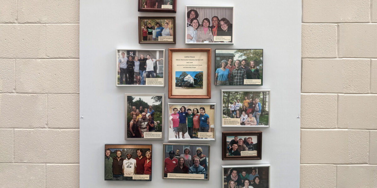 ​Photos of the MVS unit participants hang in a foyer at Prairie Street Mennonite Church. Photo by Zachary Headings.