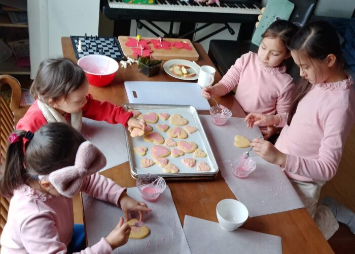 ​Jae Young Lee and Karen Spicher's children frosting Valentines Day cookies. Photo by Jae Young Lee.