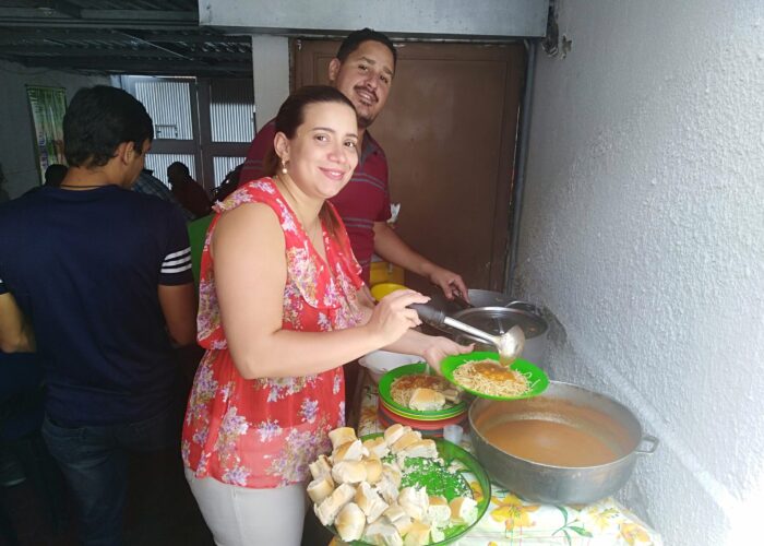 ​Helena Mirabal and Victor Mendez serve food for everyone after a service at the Mennonite church in El Paraíso neighborhood of Caracas in Venezuela. The church also shares food with their broader community