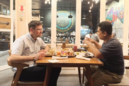 Sawatzky and Teguh Karyanto, STAKWW professor and Sawatzky's host, share conversation over a meal. Photo provided.