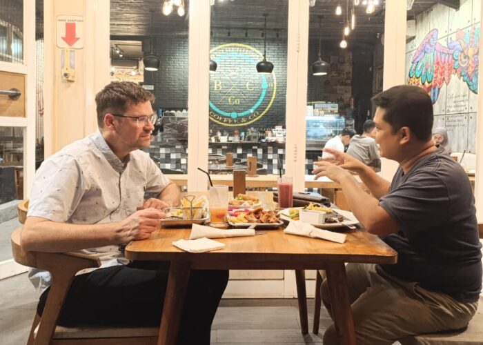 Sawatzky and Teguh Karyanto, STAKWW professor and Sawatzky's host, share conversation over a meal. Photo provided.