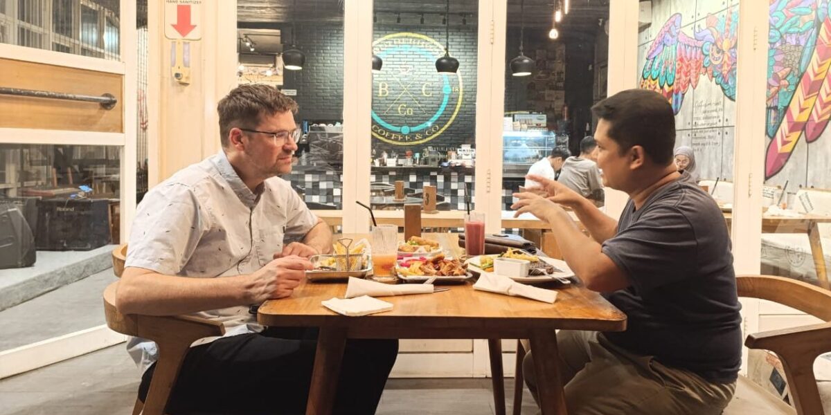 Sawatzky and Teguh Karyanto, STAKWW professor and Sawatzky's host, share conversation over a meal. Photo provided.