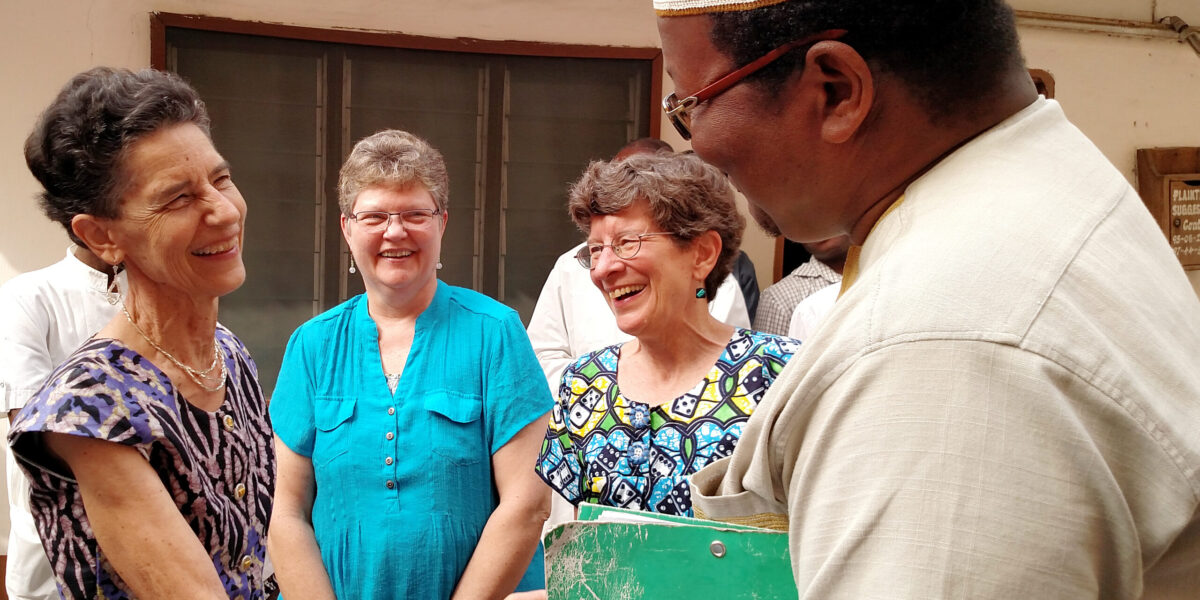 ​Janet Stucky receives congratulations from Dr. Barthélemy Dossou-Bodjrenou