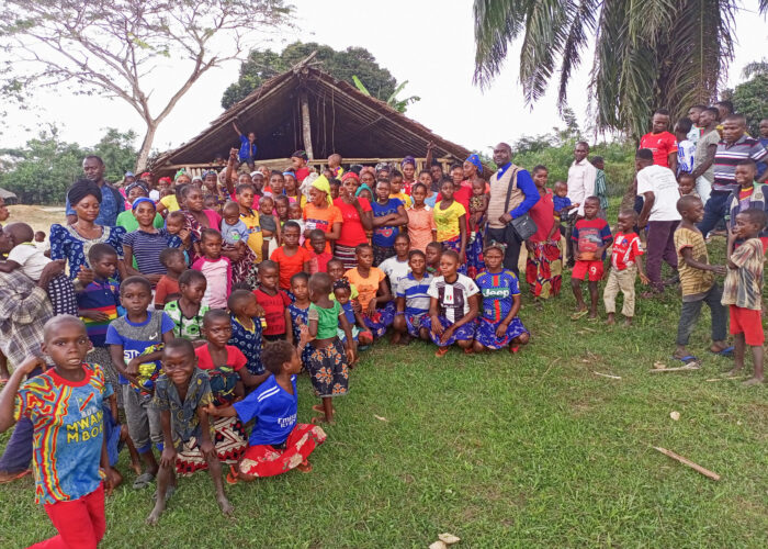 Nathan Mudiji Makumbi, standing center right with clerical collar, gathers with the Kiri Centre Mennonite Brethren congregation in the Democratic Republic of Congo after a worship service. Photographer: Glodie Kihita.