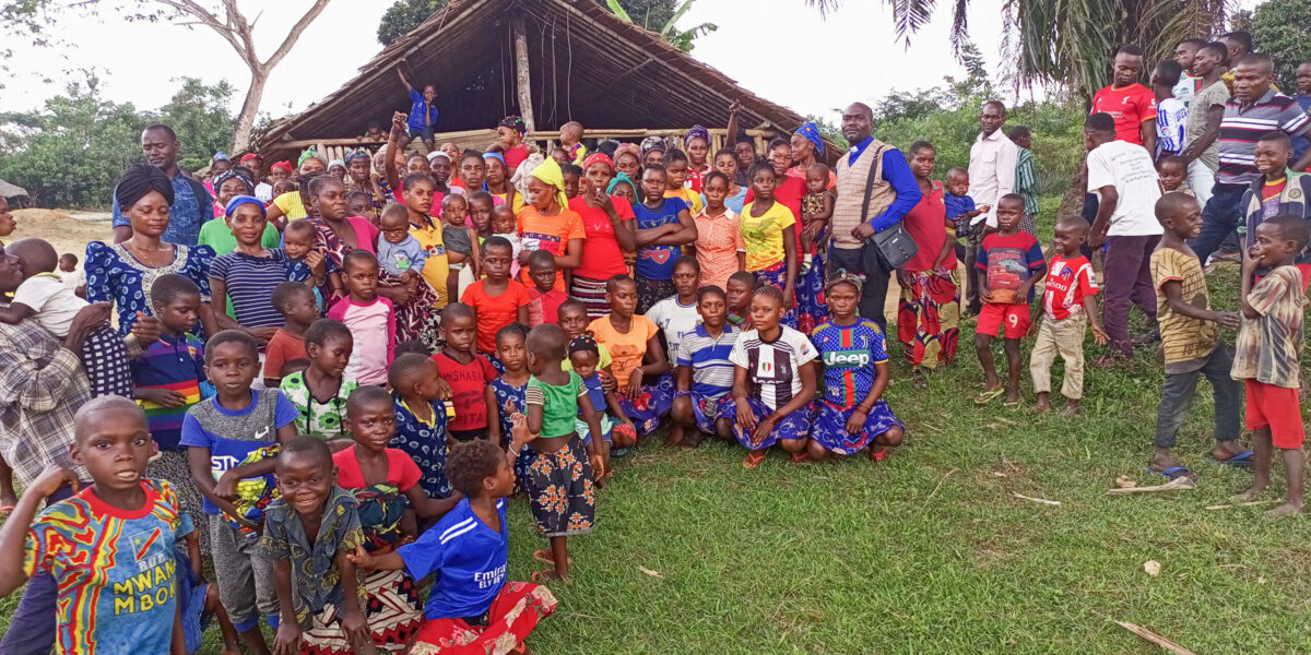 Nathan Mudiji Makumbi, standing center right with clerical collar, gathers with the Kiri Centre Mennonite Brethren congregation in the Democratic Republic of Congo after a worship service. Photographer: Glodie Kihita.