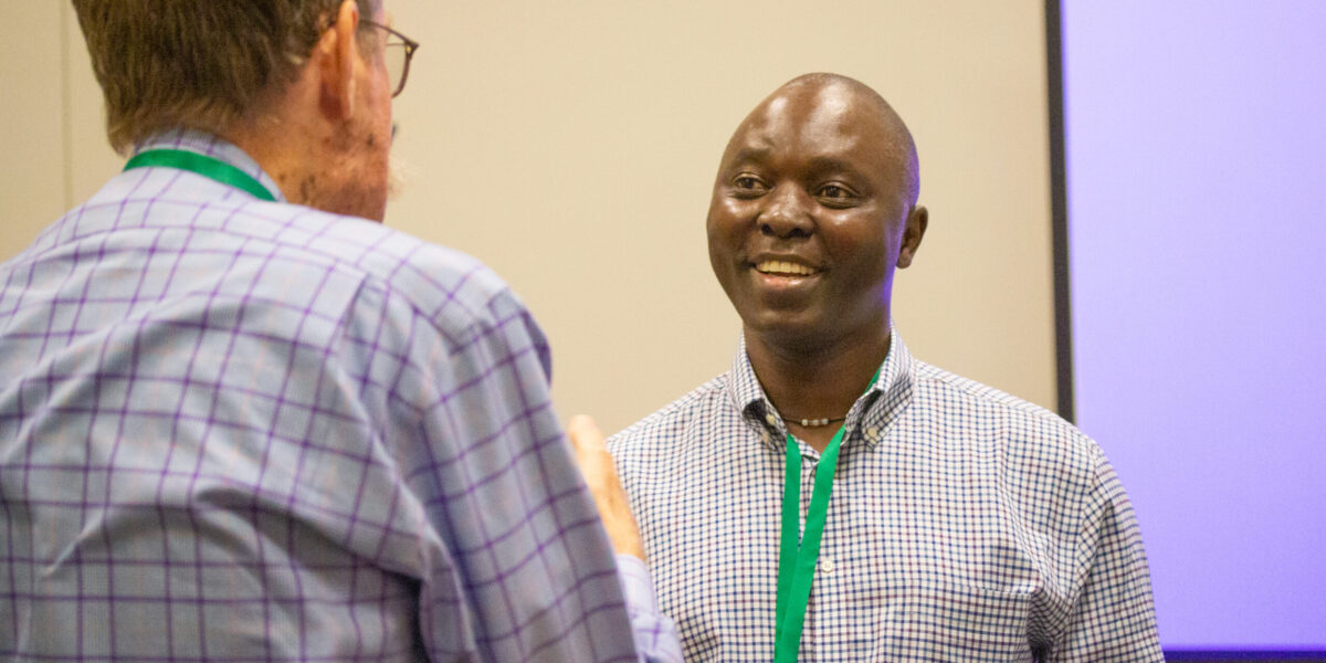 Nehemiah Chigoji (right) talks with a seminar attendee after co-leading the MennoCon21 seminar