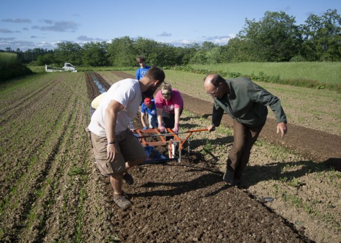Youth Venture leaders Andy and Abby Findley "break new grounds" planting potatoes with participants Matthew Rodenberg