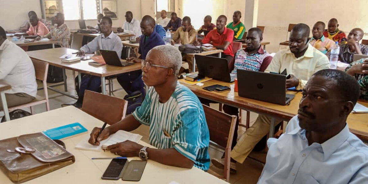 ​Sibiri Samuel Zongo and Sana Cabore take notes during Anicka Fast's Christianity in West Africa class at LOGOS University in Ouagadougou