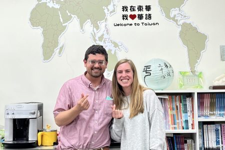 Caleb and Stephanie Schrock-Hurst pose with "finger hearts" (a popular Taiwanese photo gesture, like the peace sign) in the National Dong Hwa University Chinese Language Center office.