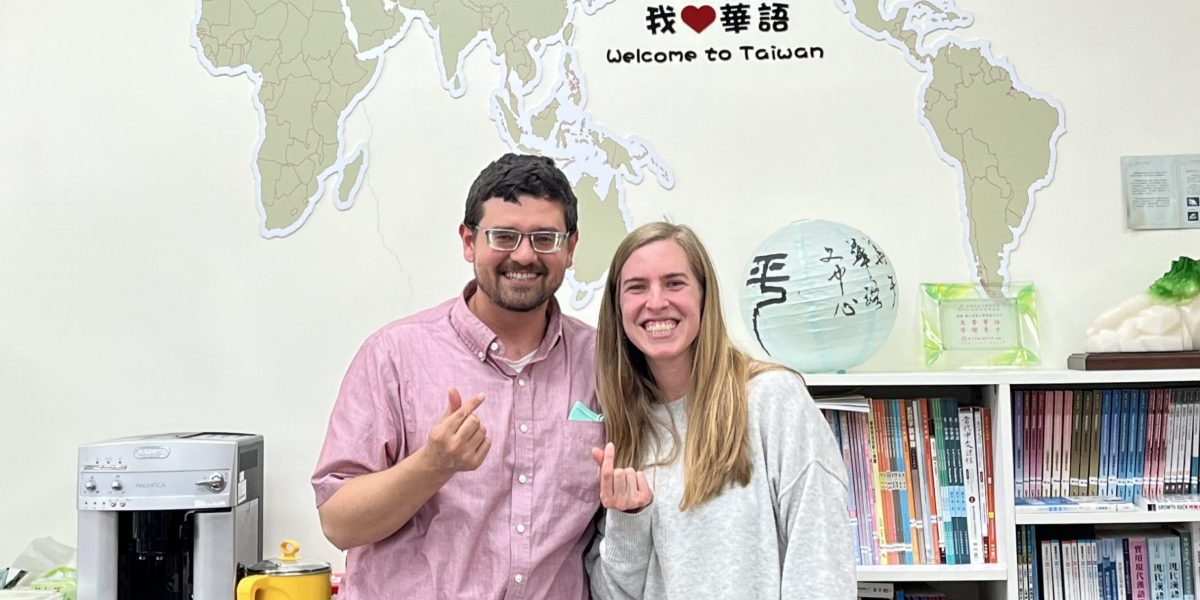 Caleb and Stephanie Schrock-Hurst pose with "finger hearts" (a popular Taiwanese photo gesture, like the peace sign) in the National Dong Hwa University Chinese Language Center office.