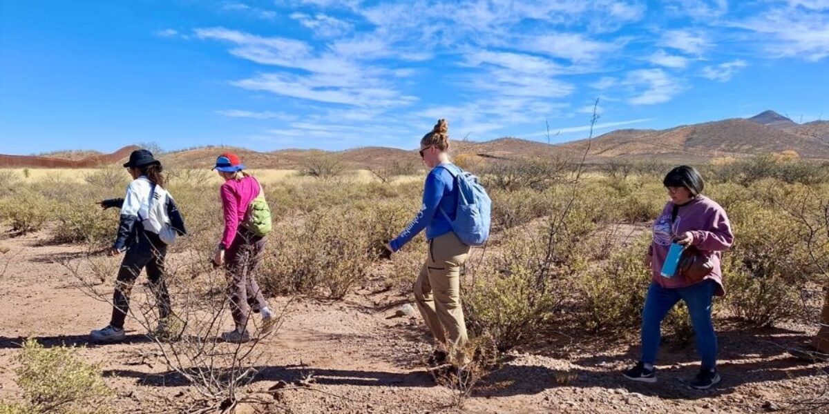Tucson MVS members walk through the desert in Mexico near the U.S. border wall. From left are Zing Bawi Ken, Hannah Lehman, Schyler Entz and Lisa Showalter (local program coordinator for the unit). Photo provided.
