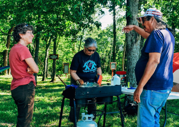 ​While Mary Mitchell cooks a Potawatomi meal for Trail of Death participants